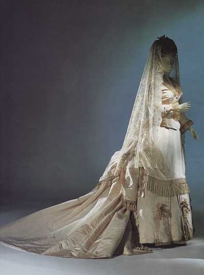  blossoms decorate the bottom of this Victorian cream silk bridal dress 